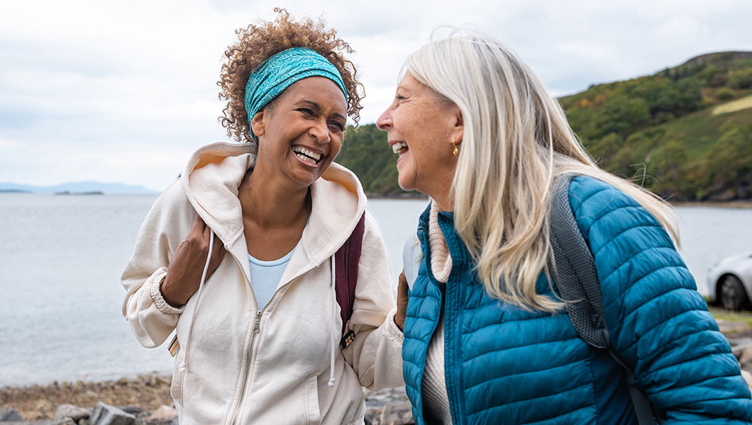 Two friends laughing and hiking