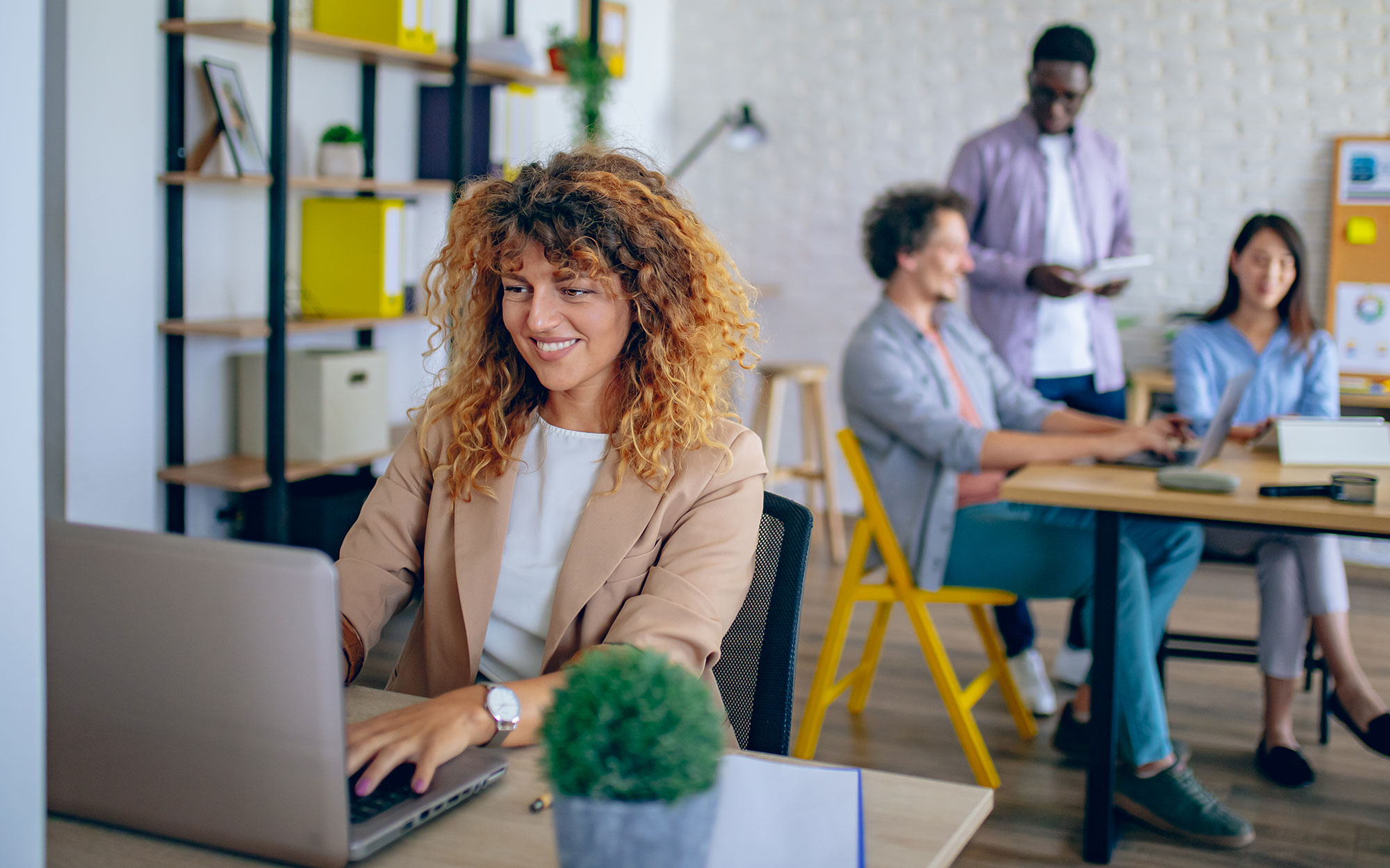 Businesswoman using laptop at modern office